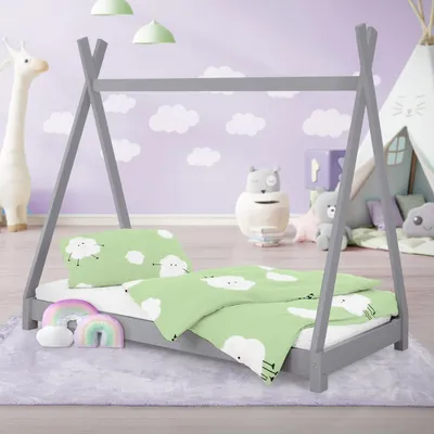 A child's bed with tipi-style frame, decorated with cloud and sheep bedding, in a nursery setting with toys and a giraffe figure.