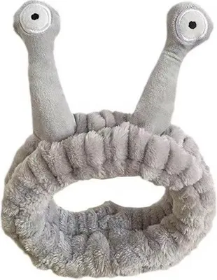 A grey cosmetic headband with two antennae-like protrusions on top, each with an eye design.