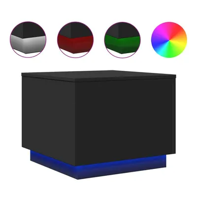 A black cube-shaped coffee table with blue LED lighting around its base, shown against a white background. Several circular insets above the table show close-ups of its corners with different color lighting options (gray, red, green) and a color wheel.