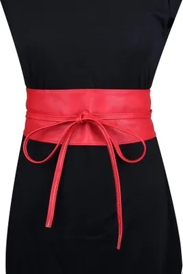A person wearing a black dress with a red obi belt.