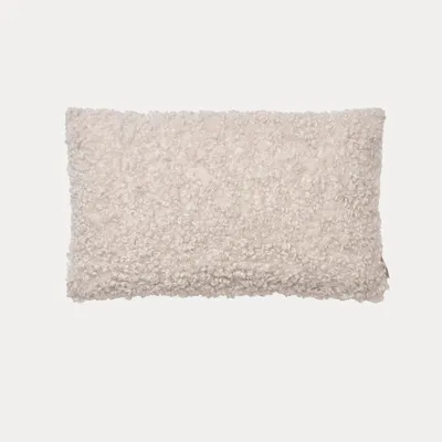 A fluffy, rectangular pillow cover is centered on a light gray background.