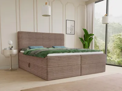 A boxspring bed with two storage drawers is shown in a bedroom setting with a large window overlooking a forest.
