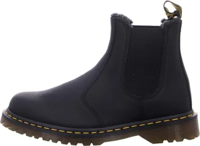 A side view of a black Dr. Martens Chelsea boot.