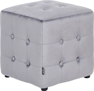 A gray velvet cube ottoman with button tufting and four small black feet.