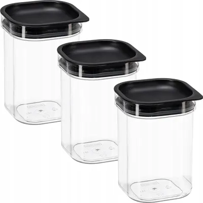 Three clear plastic food storage containers with black lids are arranged diagonally on a white background.