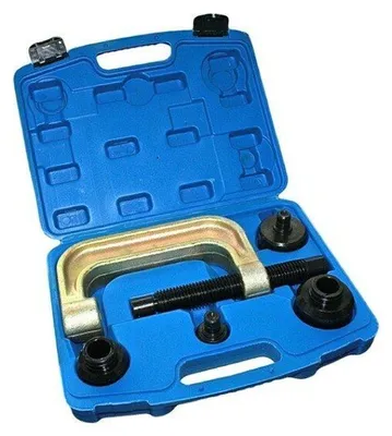A tool kit for Mercedes steering rods, including a C-clamp and various adapters, laid out in its blue plastic case.