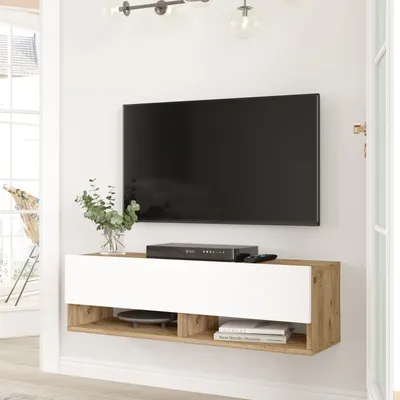 A wall-mounted TV stand with a TV mounted above it.