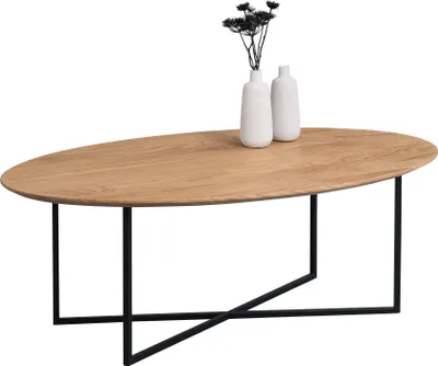 A wooden oval coffee table with black metal legs, decorated with two white vases and dried flowers.