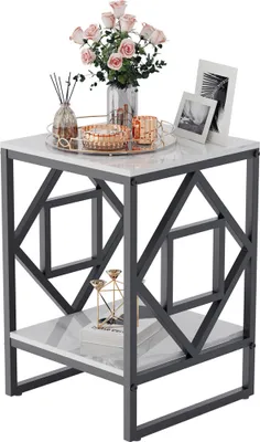 A decorative side table with marble-look top and geometric metal frame, adorned with flowers, candles, and picture frames.