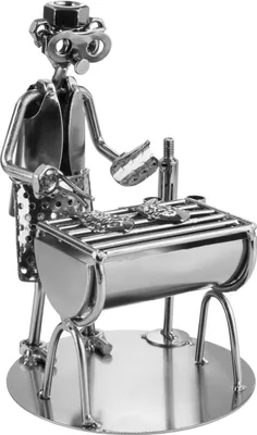 A metal figurine of a person grilling fish on a barbecue.