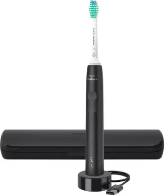A black electric toothbrush with its charging base and travel case, presented on a white background.