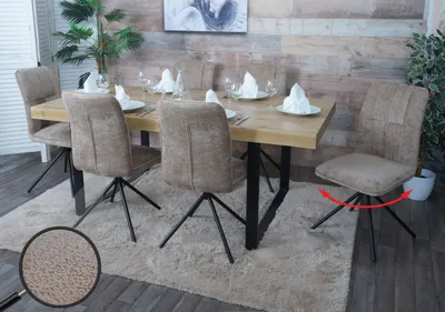 A dining room setting with a wooden table and chairs.