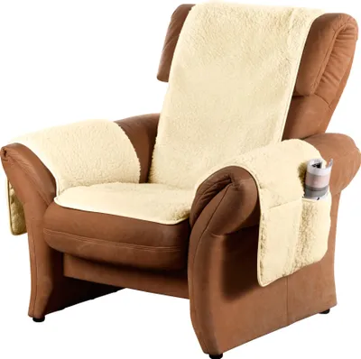 A brown leather armchair with cream-colored fleece seat and back covers, and armrest covers with pockets.