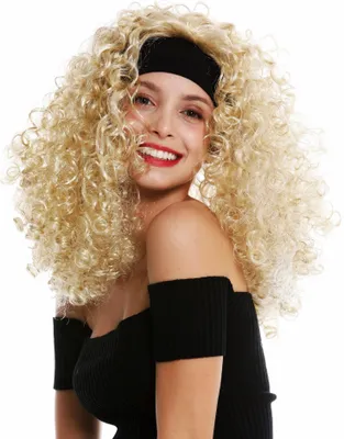 A woman wearing a black off-the-shoulder top and a blonde curly wig with a black headband, smiling at the camera.