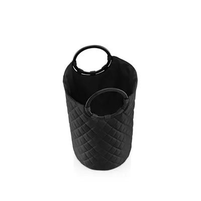 A black laundry basket with quilted diamond pattern and two black handles.