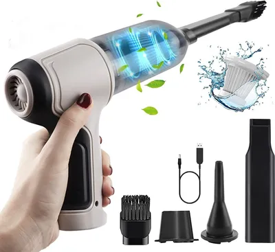 A hand holding a cordless vacuum cleaner with various attachments shown around it.