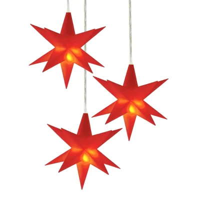 Three red star-shaped lights hanging from strings against a white background.