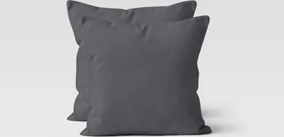 Two dark gray square pillows are shown against a white background.