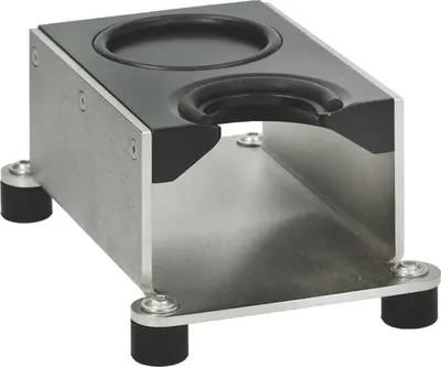 A close-up shot of a coffee tamper holder, made of brushed metal and black rubber.