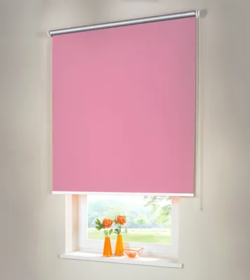 A pink roller blind is shown covering a window, with a view of greenery outside.