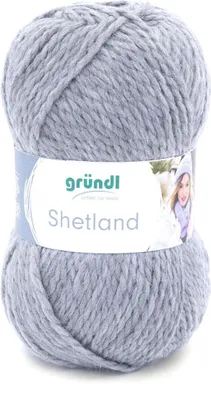 A ball of grey yarn with a label on it, and a partial image of a person wearing a scarf and hat.