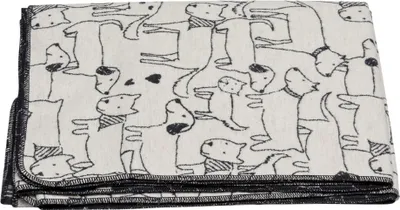 A folded blanket with a pattern of dogs.