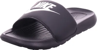 A black Nike slide sandal is shown from a slightly elevated side angle against a white background.