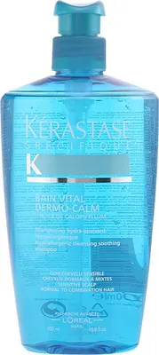 A bottle of Kerastase shampoo with a pump dispenser.