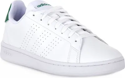 A white Adidas sneaker with green accents.