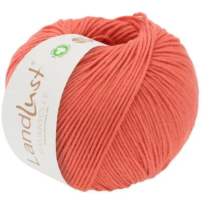 A ball of coral-colored yarn with a label.
