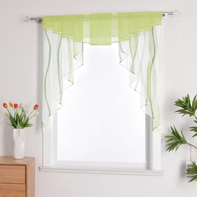 A sheer green and white valance curtain is displayed over a window. To the left, a white vase with tulips sits on a wooden dresser.