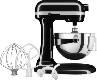 A black KitchenAid stand mixer with its accessories laid out in front of it, on a white background.