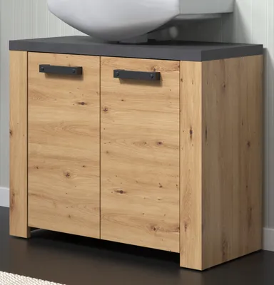 A bathroom vanity cabinet with a sink basin on top, set against a striped wallpaper.