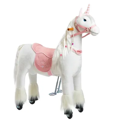 A white plush unicorn toy with a pink saddle and bridle, standing on a white background.