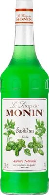 A bottle of Monin Basil syrup on a white background.