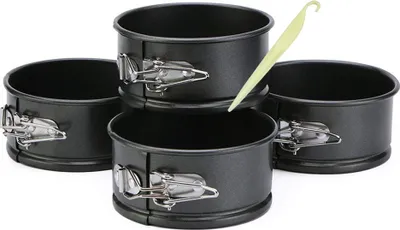 A set of four round springform cake pans and a yellow plastic scraper.