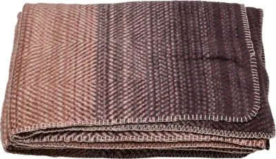 A folded blanket with a gradient pattern.