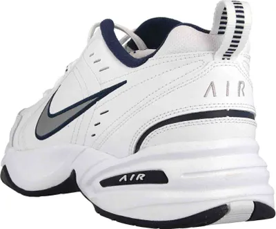 A side view of a white Nike Air Monarch IV sneaker.