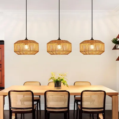 A dining room with a wooden table and chairs, illuminated by three rattan pendant lights.