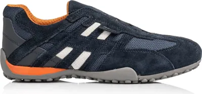 A side view of a navy blue Geox sneaker with orange accents and white stripes.