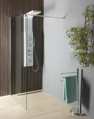 A modern bathroom with a walk-in shower, shower panel, and towel rack.