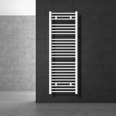 A white towel radiator is mounted on a black tiled wall, with a gray tiled wall and floor in the background.