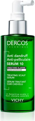 A green bottle of Vichy Dercos Anti-dandruff Serum with a white pump dispenser.