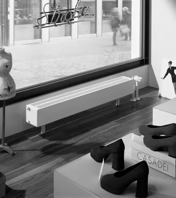 A retail store window display featuring a radiator and shoes.
