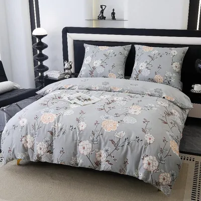 A bedroom scene with a bed dressed in floral bedding.