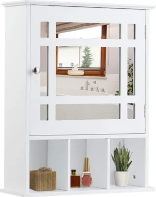 A white bathroom cabinet with a mirrored door and open shelves below, displaying a few decorative items.