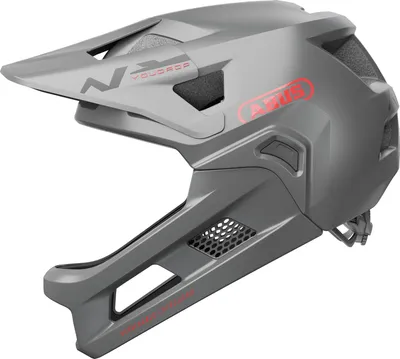 A studio shot of a grey full-face mountain bike helmet with red branding.
