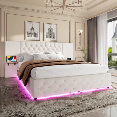 A bedroom scene featuring a white upholstered bed with LED lighting.