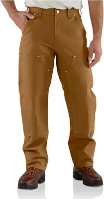 A person wearing brown work pants and brown work boots, standing against a white background.