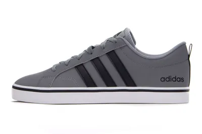 A side view of a gray Adidas shoe against a white background.
